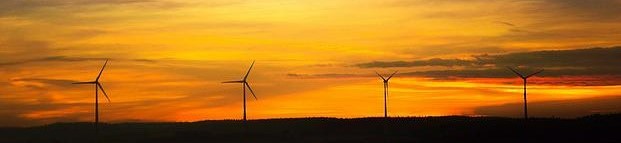 Wind turbines on a hill during sunrise